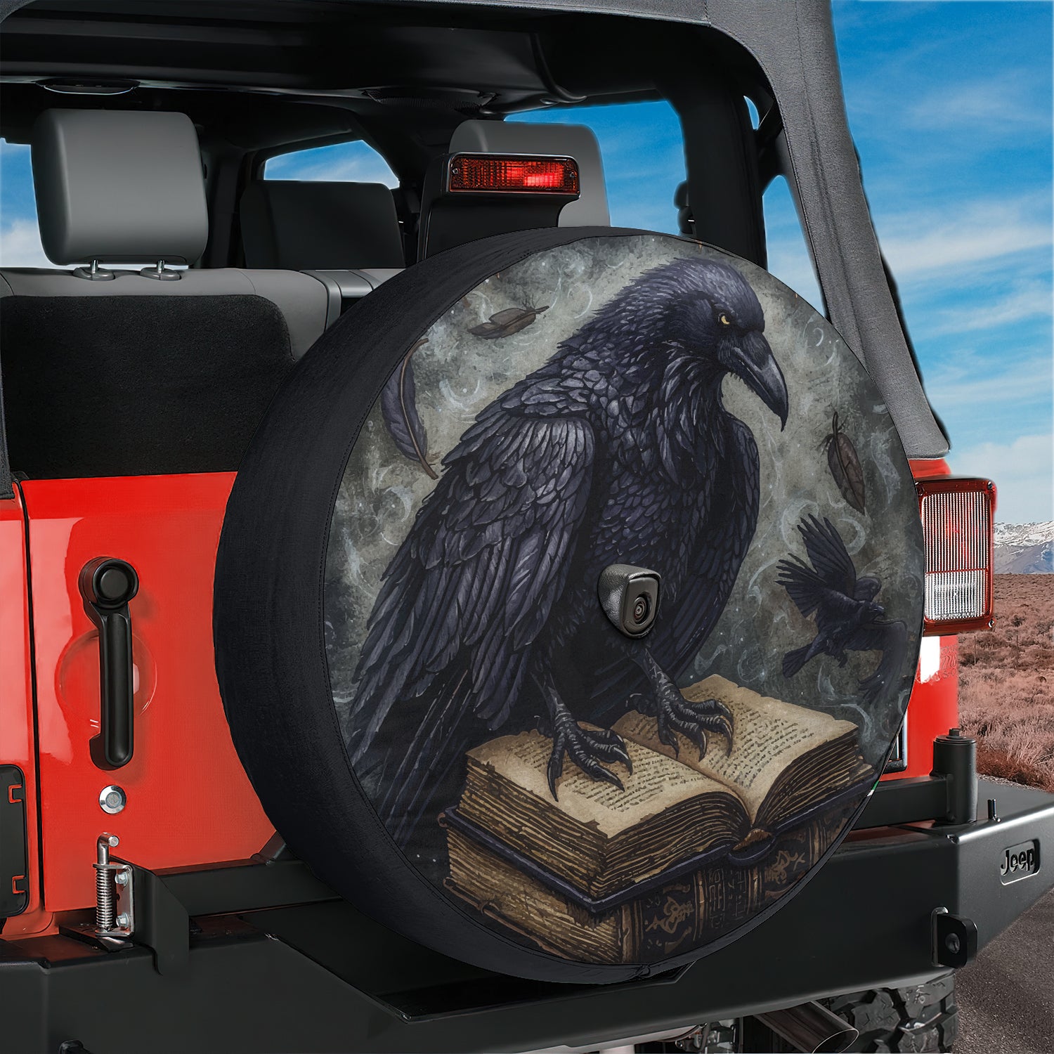 a black bird sitting on top of a book on a tire cover